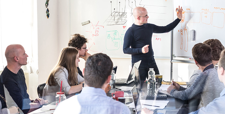 People learning at a whiteboard.