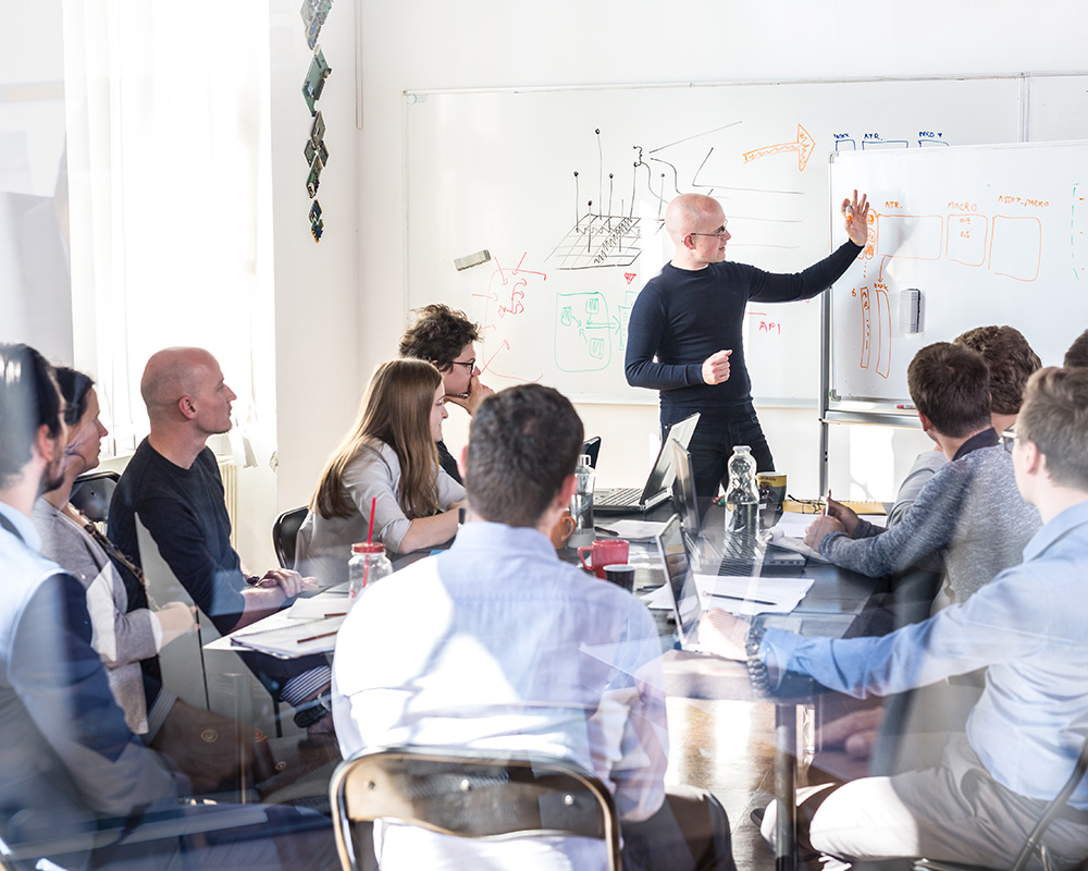 Group of people learning from a presenter